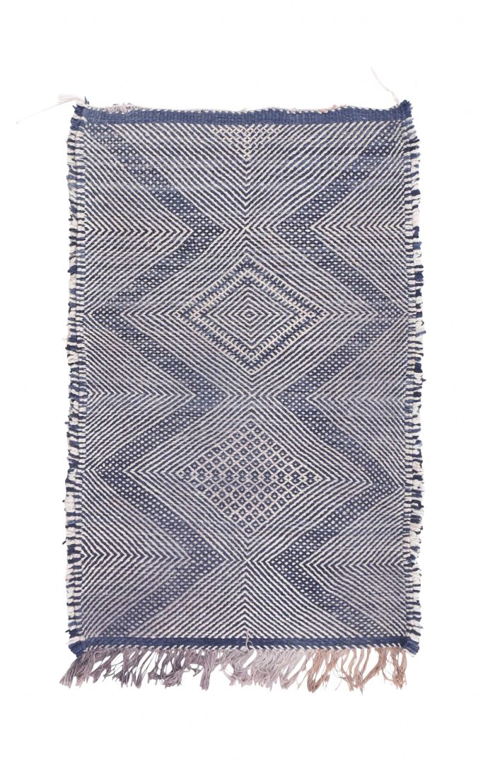 blue and white flat weave rug with Moroccan design