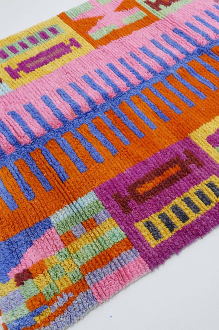 Handwoven Moroccan colorful rug with vibrant hues and intricate patterns, crafted from high-quality natural fibers for home decor.