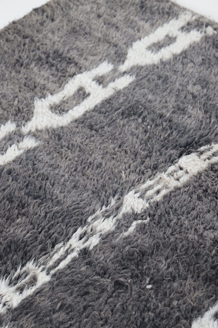 Handwoven Moroccan Black and White Abstract Rug with intricate patterns, perfect for adding sophistication to any room.