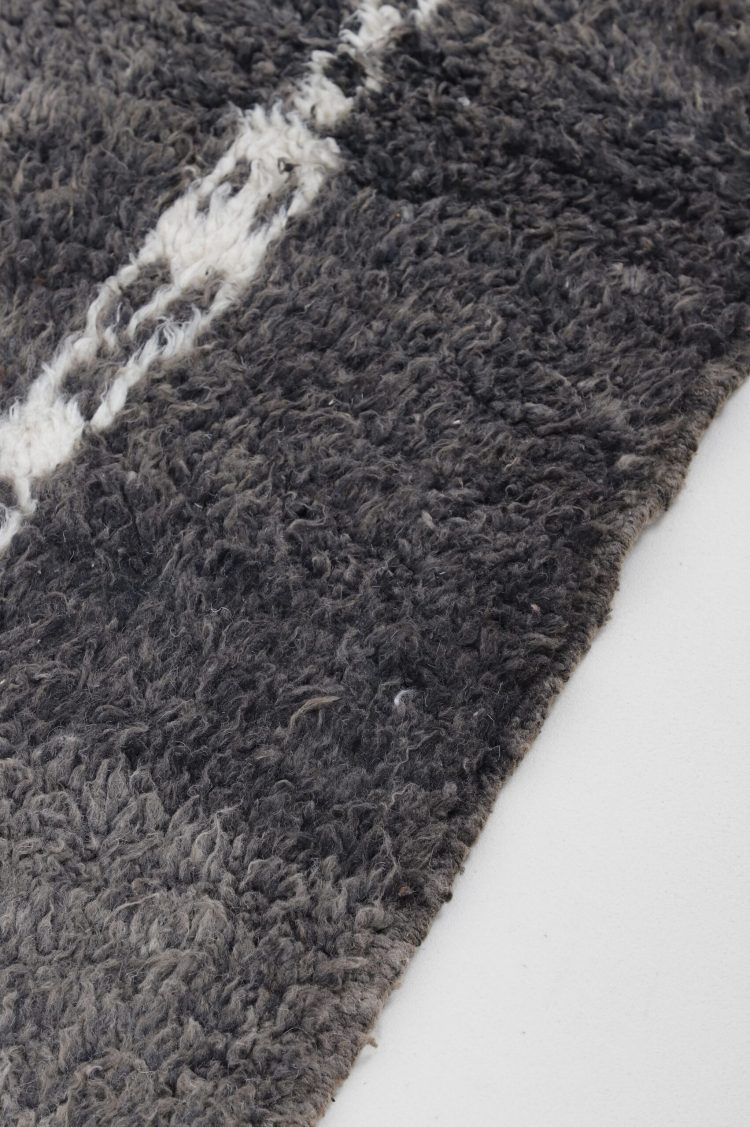 Handwoven Moroccan Black and White Abstract Rug with intricate patterns, perfect for adding sophistication to any room.