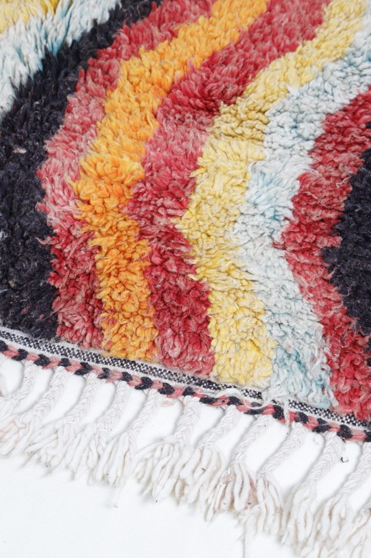 Handwoven Abstract Moroccan Rug with vibrant colors and intricate patterns.