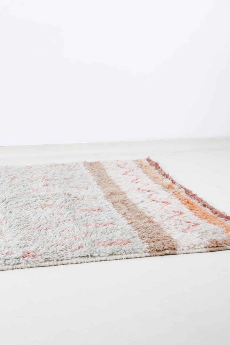 Handcrafted Moroccan shag rug with intricate patterns and plush wool pile.