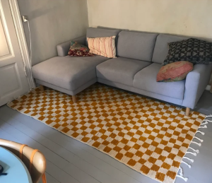 Black and white checkered outdoor rug on a patio