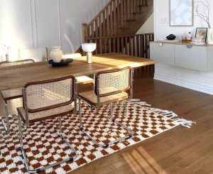 Gray and white checkered rugs on an outdoor patio with furniture