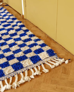 Wool blue checkered rug in a cozy bedroom.