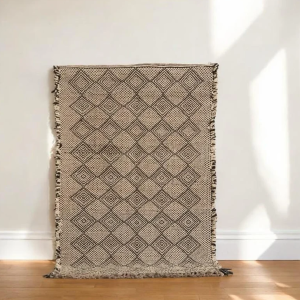 A neutral-toned Moroccan Kilim rug in beige and cream with a minimalistic pattern, suitable for modern and contemporary interiors.