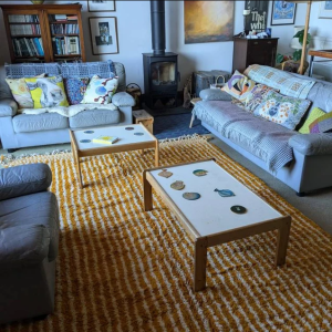 A minimalist bedroom with a soft, wool Berber rug in neutral tones under the bed, creating a calm and cozy ambiance.