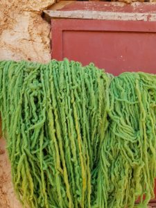 Female artisan spinning wool for Moroccan rugs